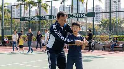 Coach teaching junior at Victoria Park