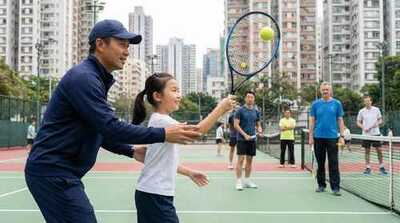 Coach teaching junior serve at Victoria Park