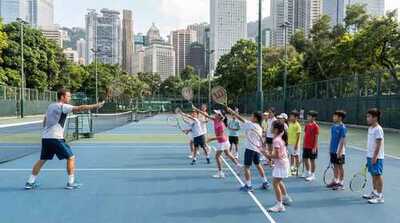 Junior group practicing serves at Victoria Park