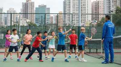 Junior group practicing ground strokes at Victoria Park