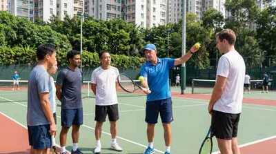 Coach demonstrating serve at Victoria Park