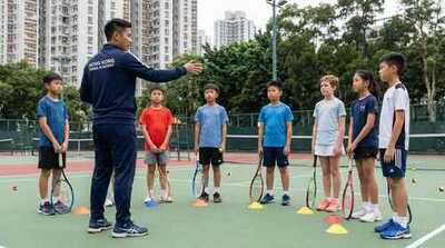 Coach teaching court movement to juniors at Victoria Park